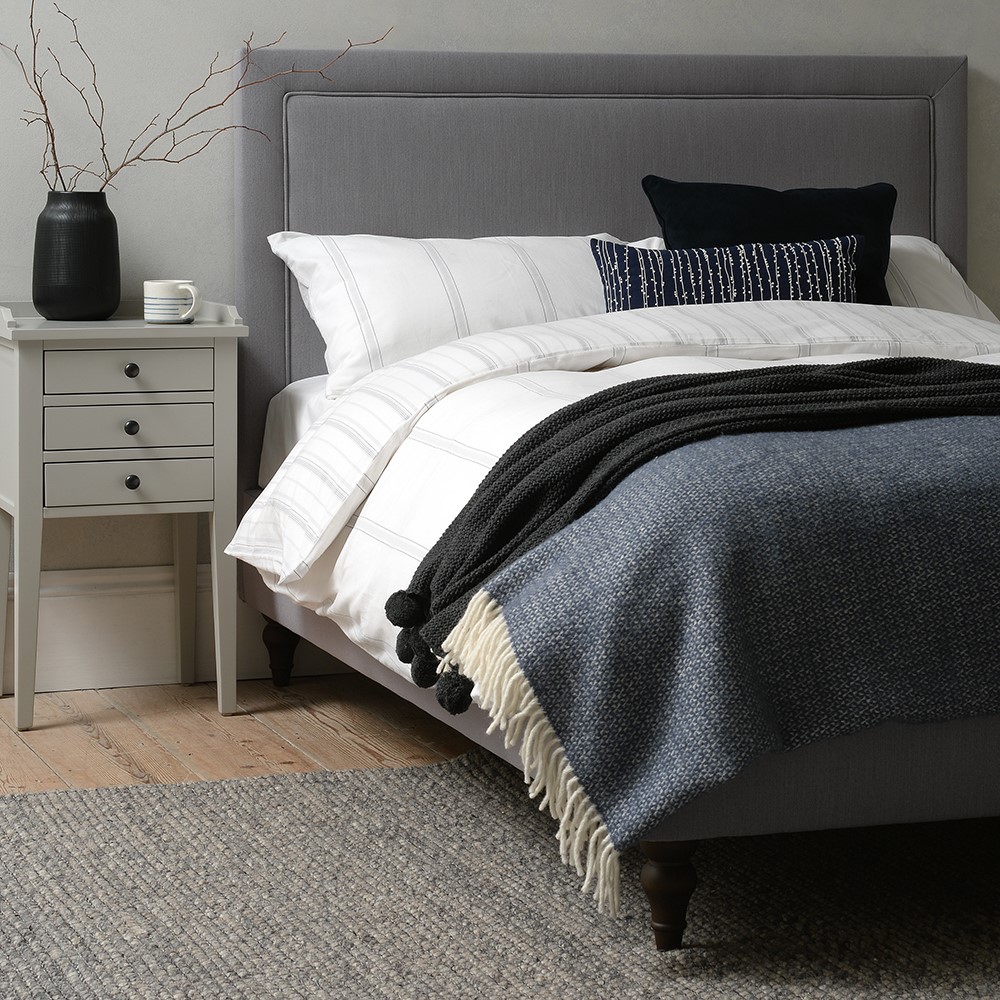 grey linen upholstered bed